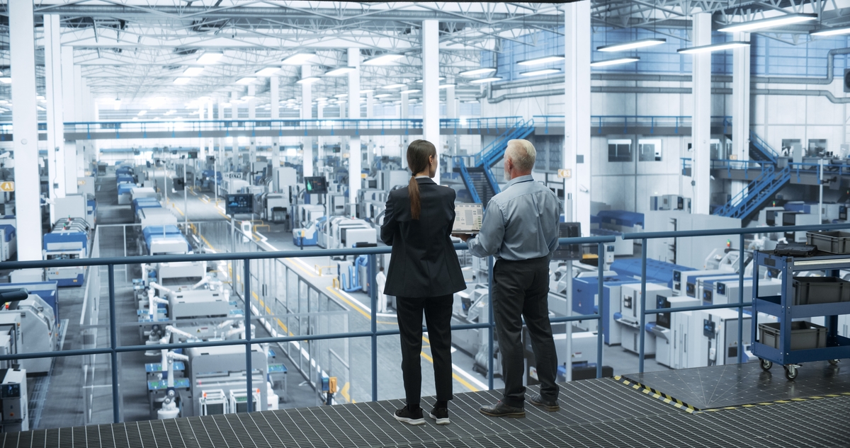 Middle,Aged,Engineer,And,Female,Scientist,Standing,With,Their,Back,