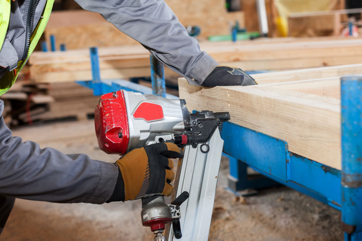 Building,A,Wall,For,Frame,House.worker,Use,Framing,Nailer,To