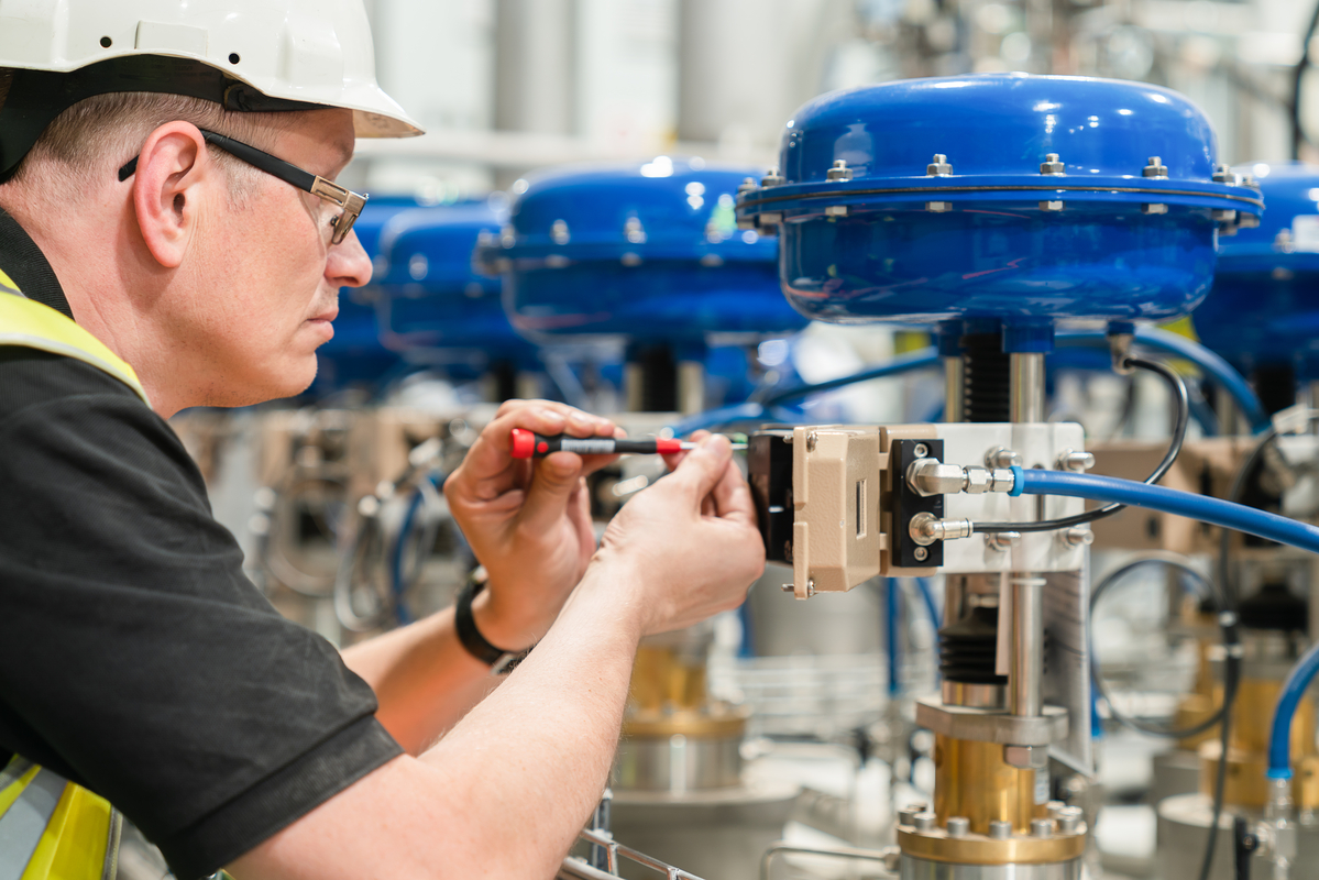 An,Engineer,Checks,An,Pneumatic,Valve,With,A,Screwdriver